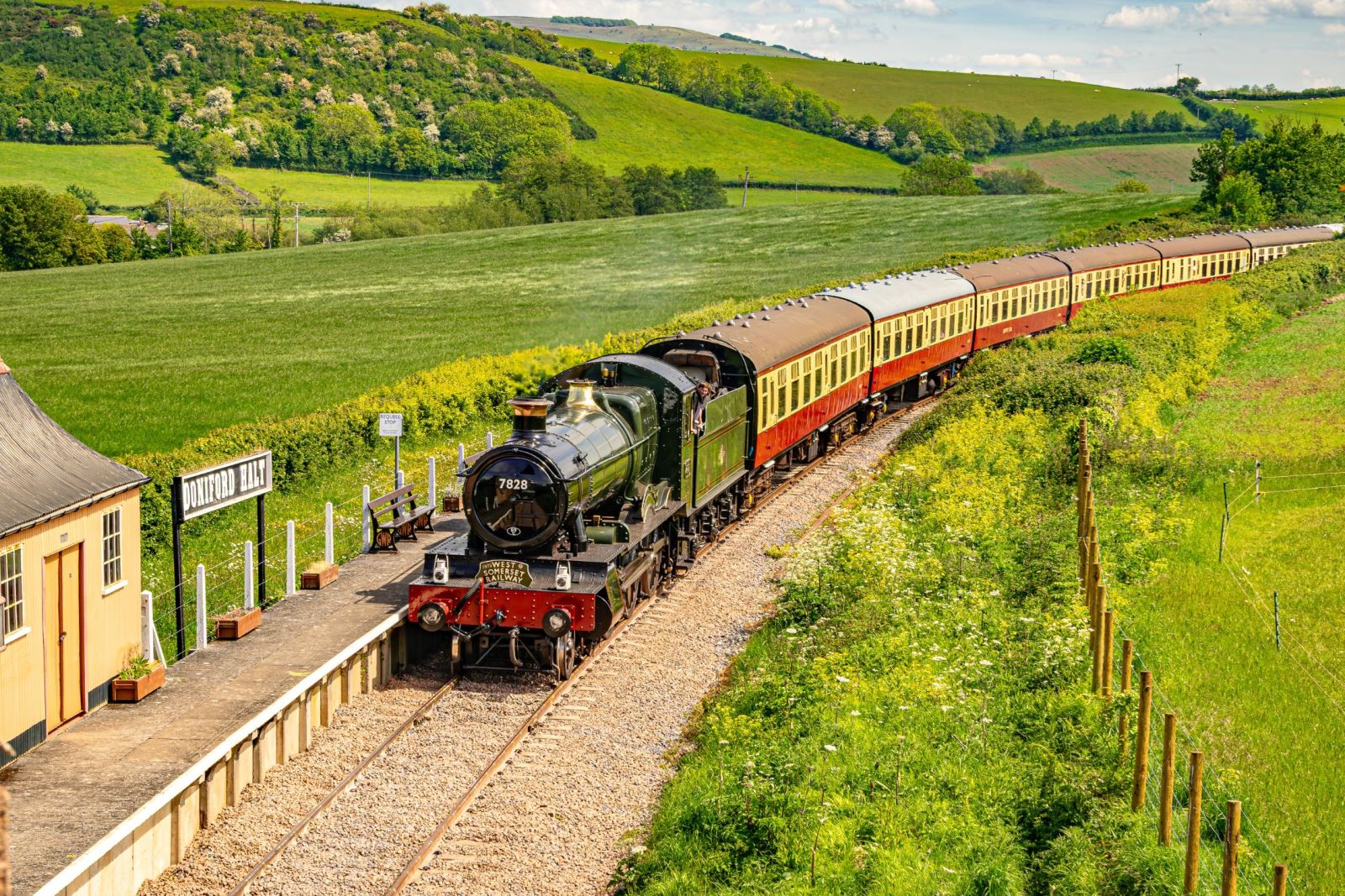 A steam train from West Somerset Railway cutting through the Somerset countryside